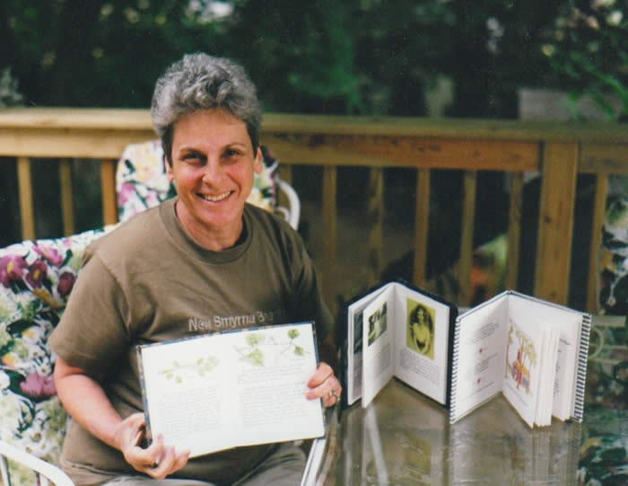 Ann Cutler with handmade books of family stories