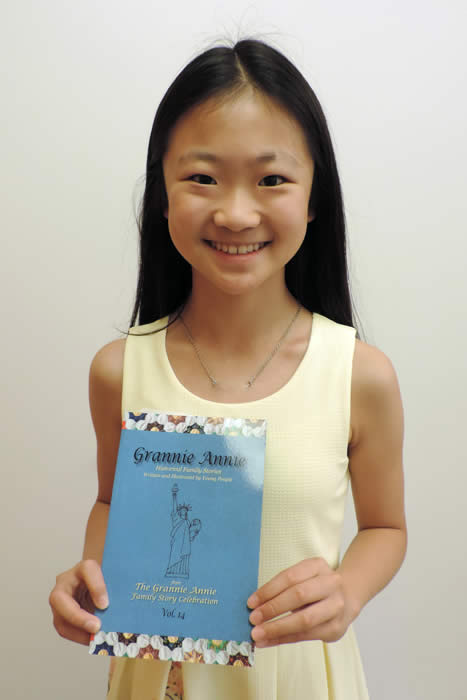 Grannie Annie published student 2019 Grannie Annie published student 2019, holding a copy of "Grannie Annie, Vol. 14"