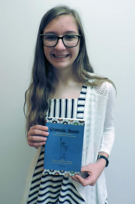 Grannie Annie published student 2019 Grannie Annie published student 2019, holding a copy of "Grannie Annie, Vol. 14"