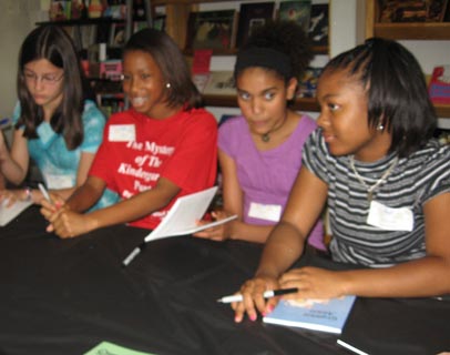 students signing books at book signing