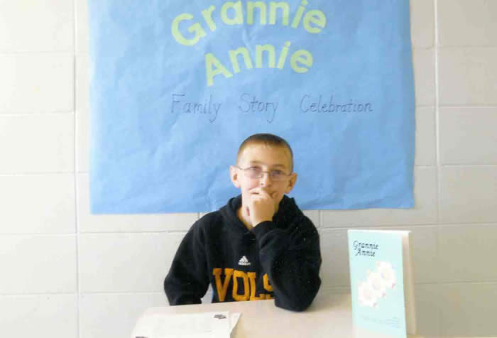Grannie Annie Storykeeper with book and banner
